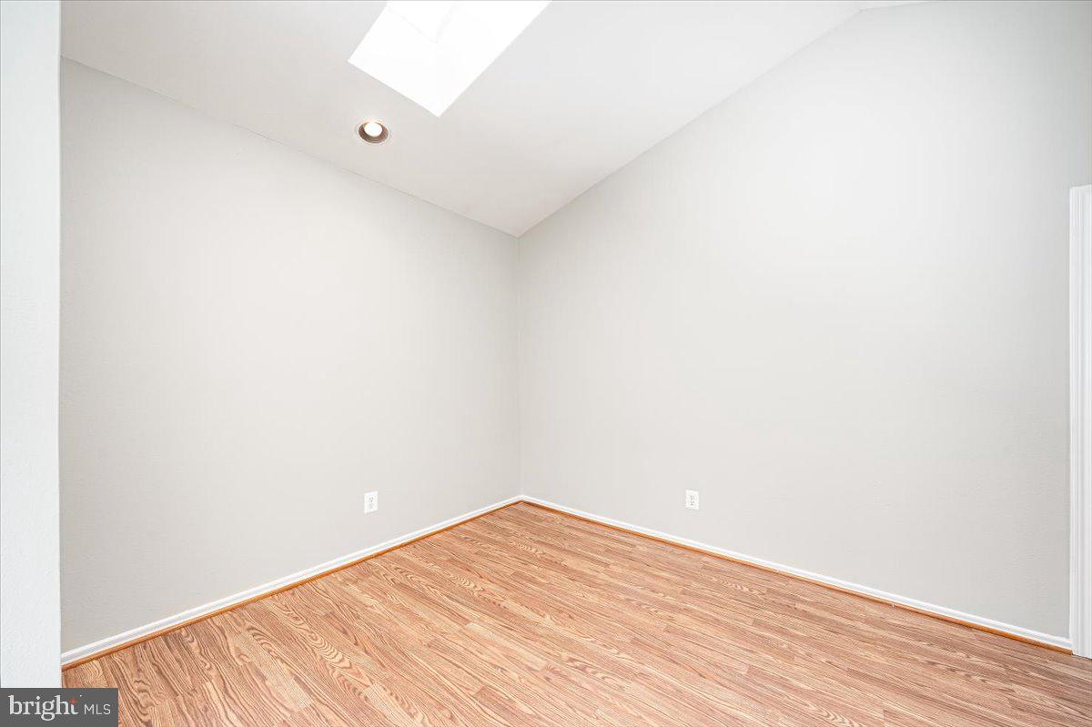 9901 Boysenberry Way, Unit 24018 Gaithersburg, MD 20879 - Photo 7 of 26 a view of empty room with wooden floor