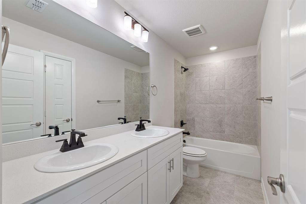 1847 Cole Road Van Alstyne, TX 75495 - Photo 14 of 26 Guests will enjoy their own vanity space in this thoughtfully designed guest bath.