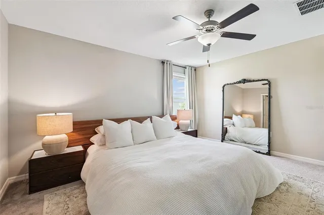 a bedroom with bed and a chandelier