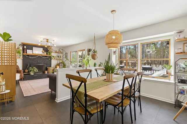 a view of a dining room with furniture large windows and wooden floor