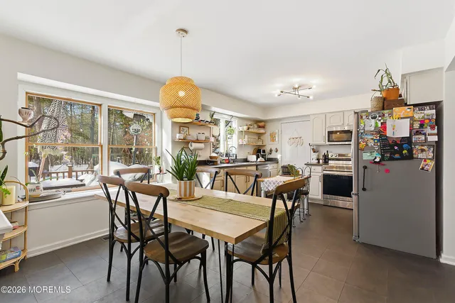a dining room with furniture and window
