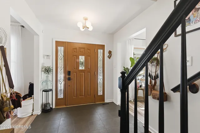 a view of an entryway with wooden floor and stairs