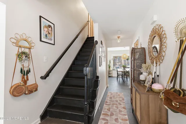a view of entryway and hall with wooden floor