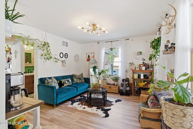 a living room with furniture and flowers