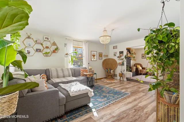 a living room with furniture and a chandelier