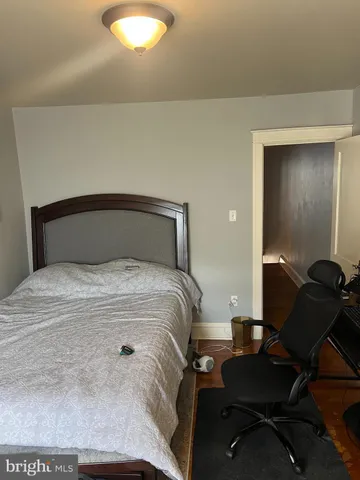 a bedroom with a bed and a mirror