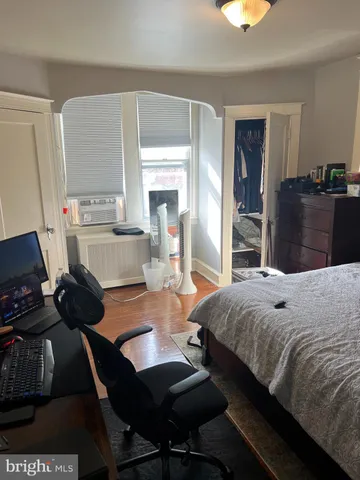 a bedroom with a bed and a television