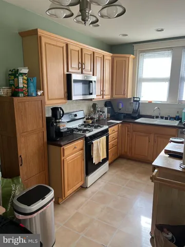 a kitchen with a sink stove and microwave