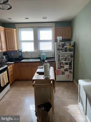 a kitchen with a window a sink and a counter