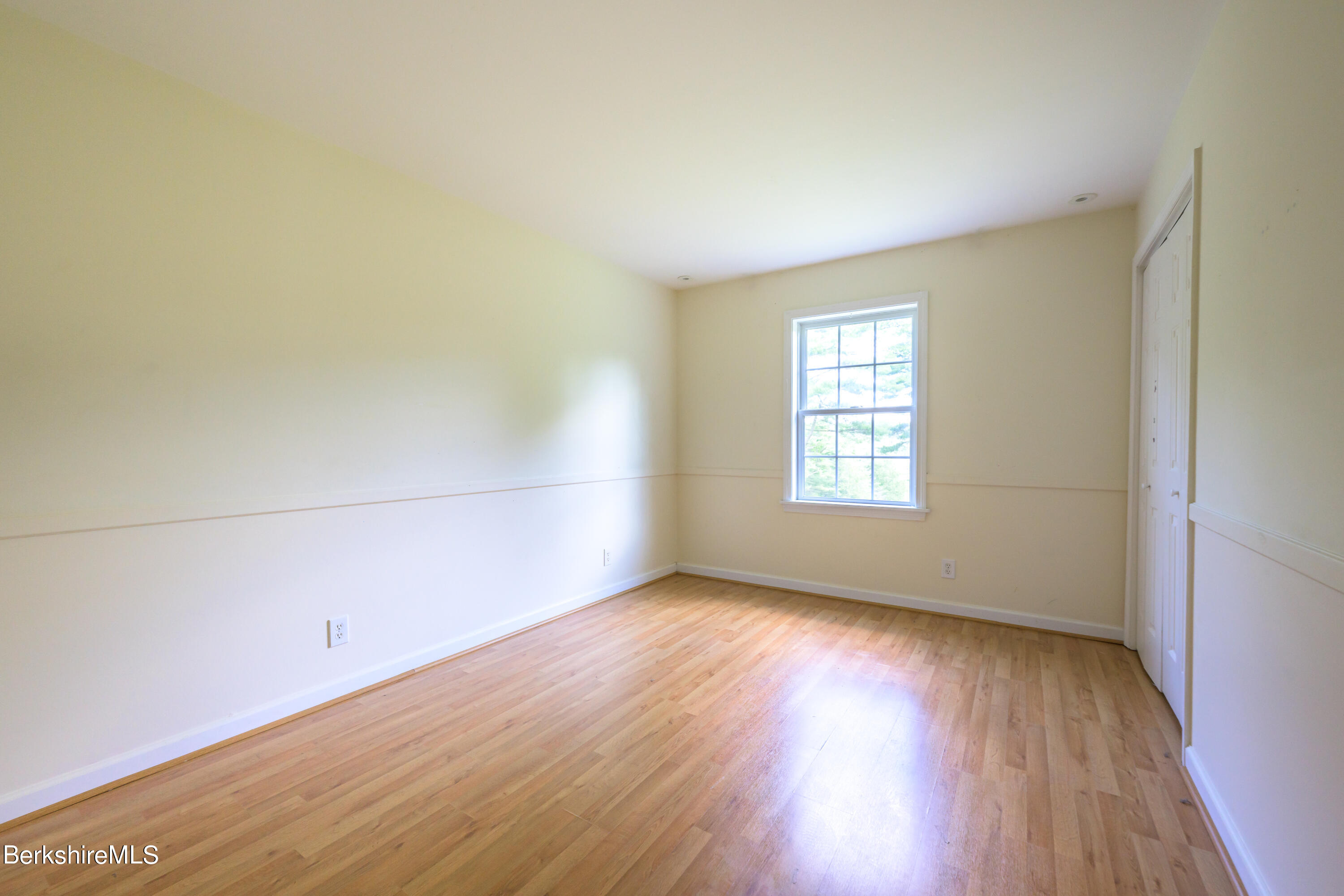 50 Branch Farm Road Richmond, MA 01201 - Photo 17 of 25 an empty room with wooden floor and windows