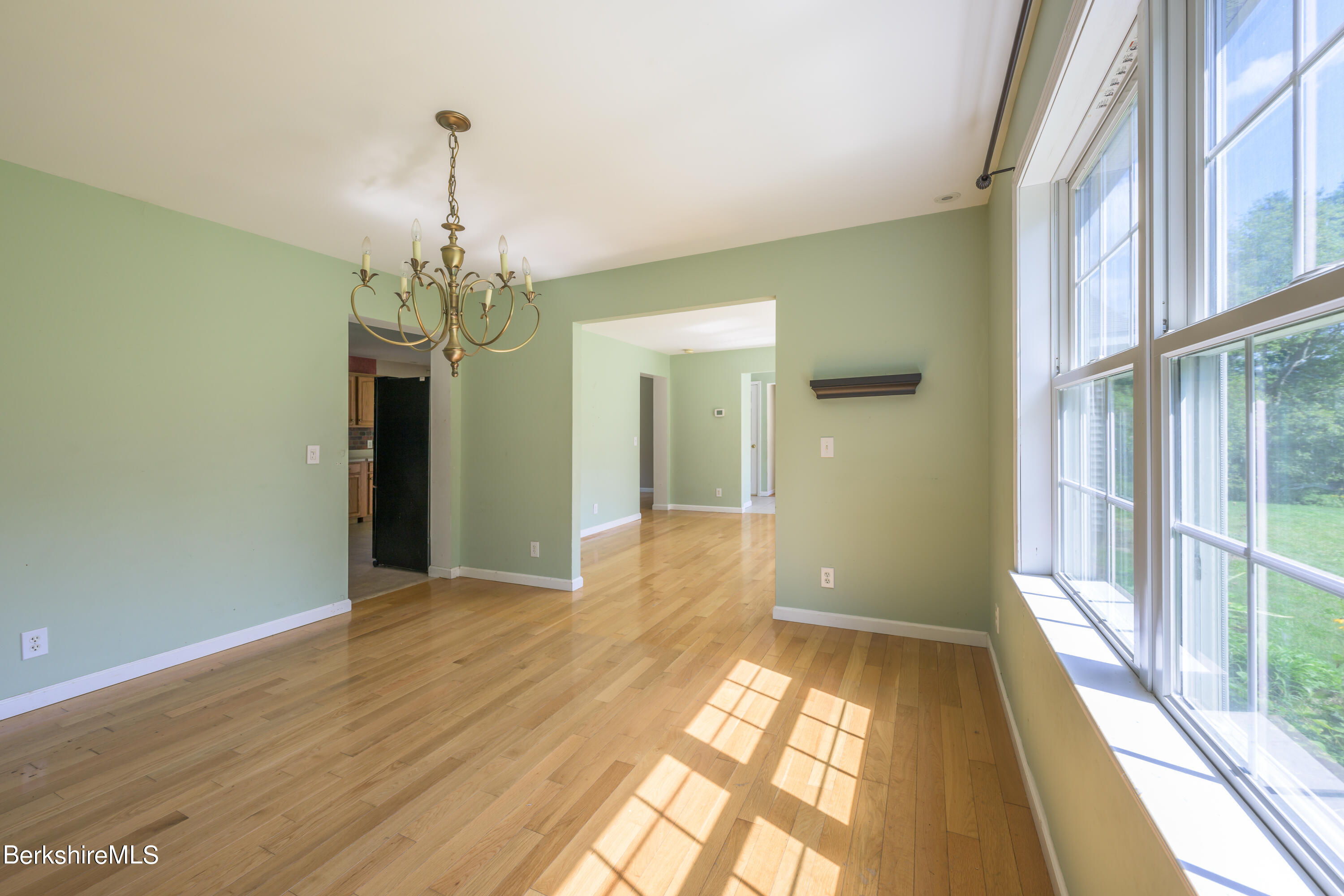50 Branch Farm Road Richmond, MA 01201 - Photo 6 of 25 a view of a hallway with wooden floor and a chandelier