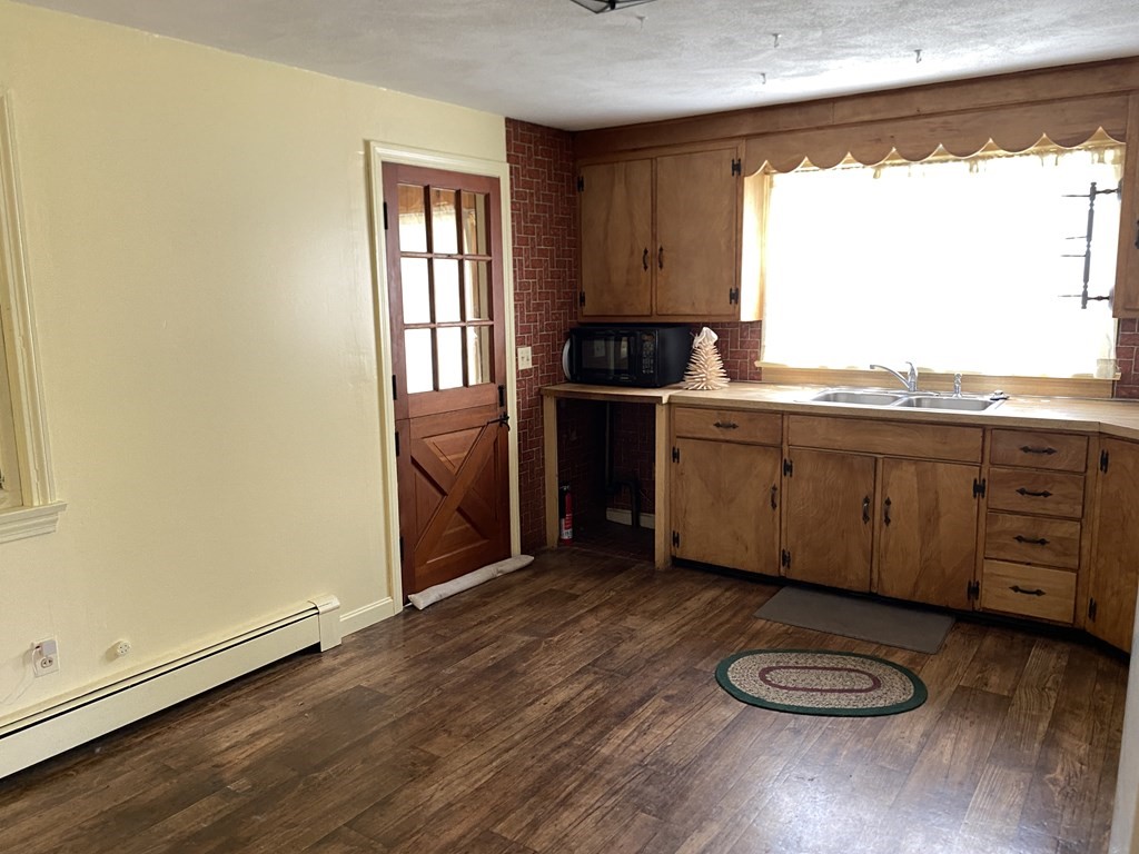31 Upper Palmer Road Monson, MA 01057 - Photo 11 of 22 a kitchen with wooden floors and sink