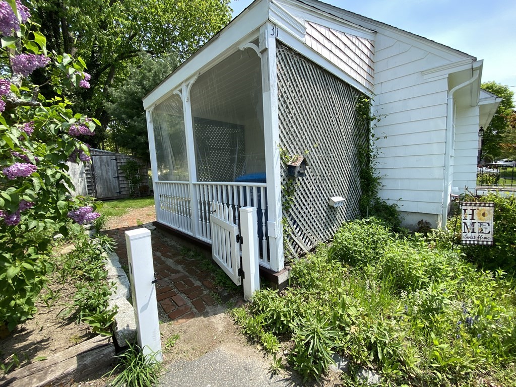 31 Upper Palmer Road Monson, MA 01057 - Photo 21 of 22 a view of a house with a small yard and flower plants