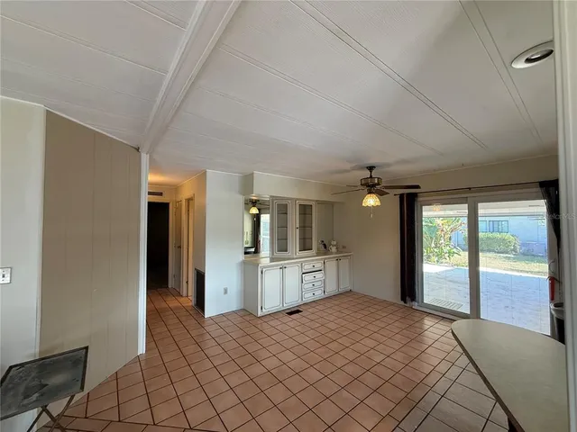 a large bedroom with a large bed and chandelier