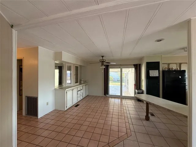 a large white room with mirror and window