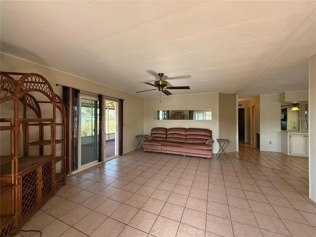 a view of a hallway with entryway and chandelier