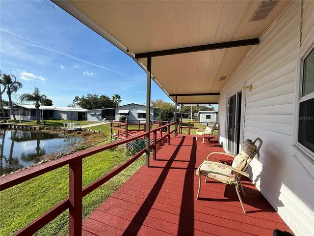 a view of a chairs and table on the wooden deck