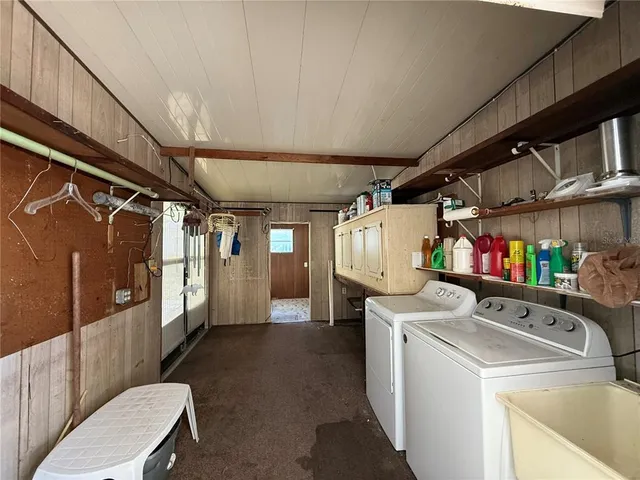 a view of a swimming pool with a yard and palm trees
