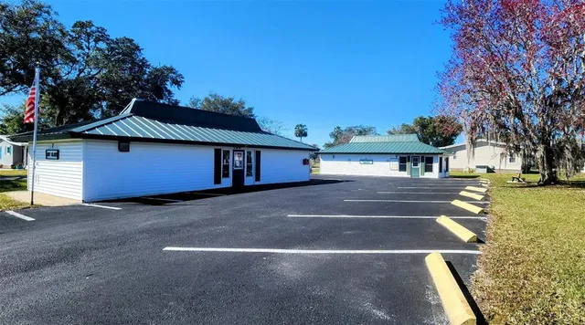 a front view of a house with a yard and tree s