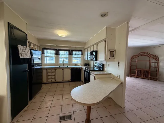 a kitchen with stainless steel appliances a refrigerator and a stove top oven