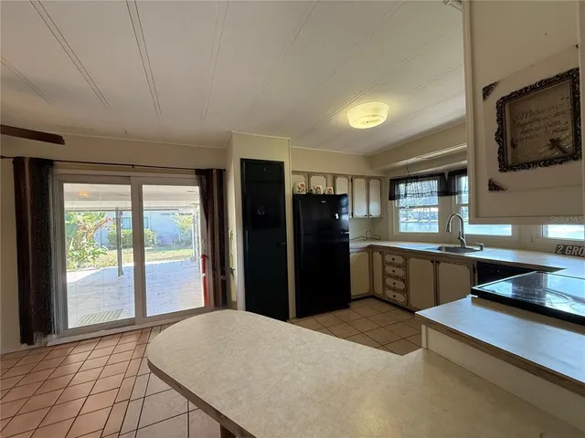 a large kitchen with a large window and stainless steel appliances