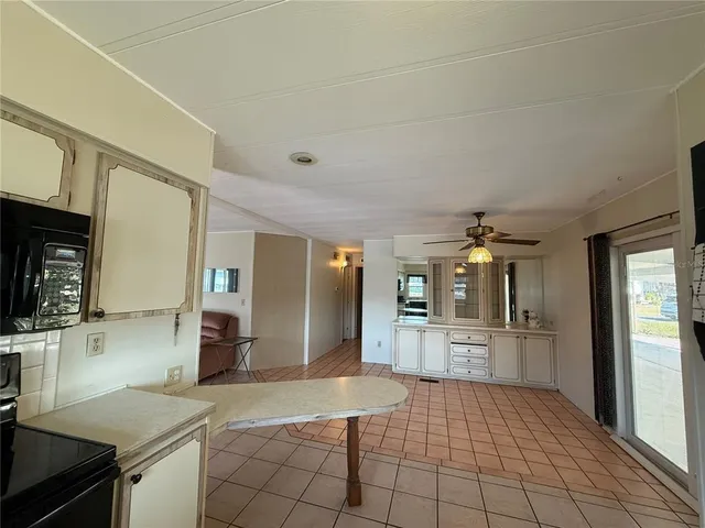 a kitchen with refrigerator and cabinets