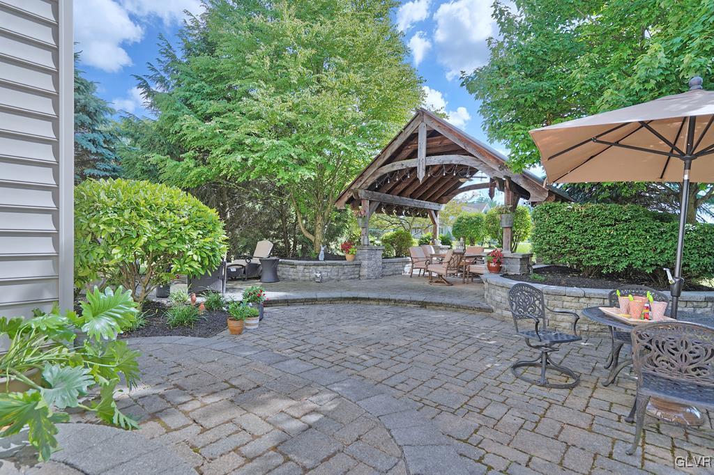 3280 Gun Club Road Nazareth, PA 18064 - Photo 31 of 34 a view of a patio with table and chairs under an umbrella