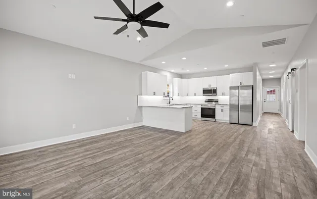 a view of a kitchen with a sink and stainless steel appliances