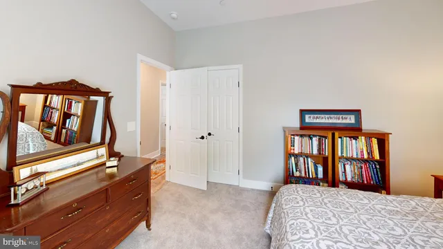 a bedroom with a bed next to a window