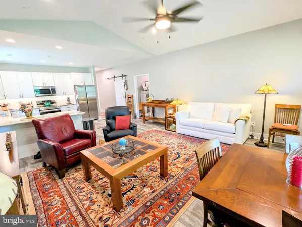 a living room with furniture a rug and a chandelier