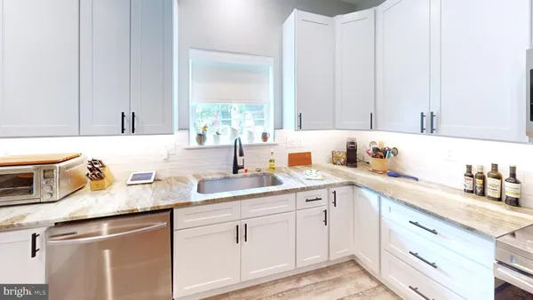 a kitchen with a sink dishwasher and cabinets