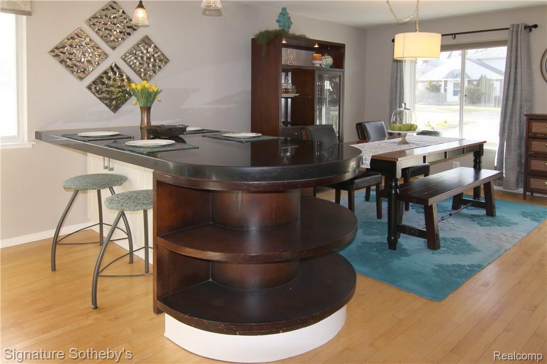 Social Island between kitchen and dining room.  Opens  to living room, such a nice way to entertain!