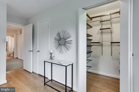 a view of a hallway with wooden floor and entryway