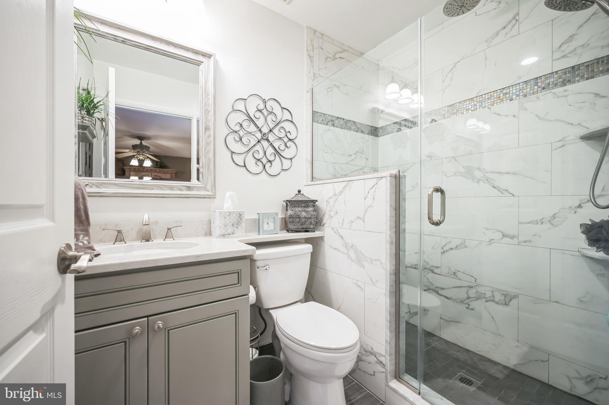 550 Sherry Drive Runnemede, NJ 08078 - Photo 18 of 28 a bathroom with a granite countertop toilet sink and a shower