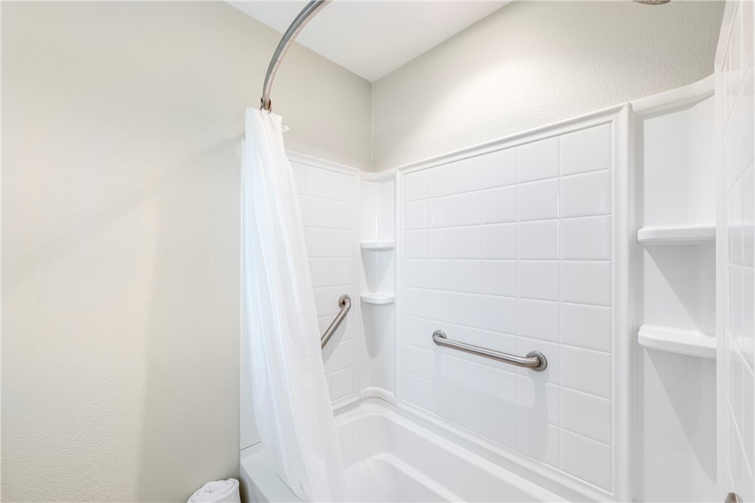 230 Cut-Off Road, Unit 101 Port Aransas, TX 78373 - Photo 21 of 30 a bathroom with a bathtub and shower
