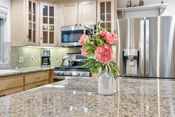 a kitchen with stainless steel appliances granite countertop a stove and a sink