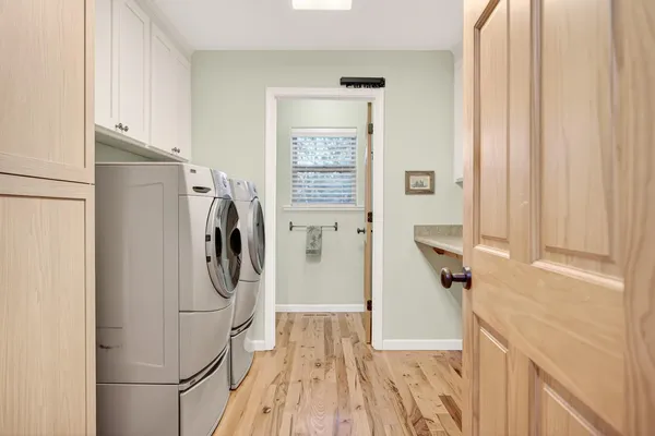 a utility room with sink dryer and washer