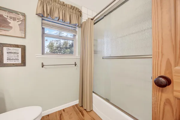 a bedroom with a bed chandelier and a window