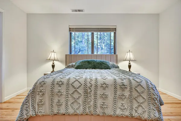 a bedroom with a bed and a window