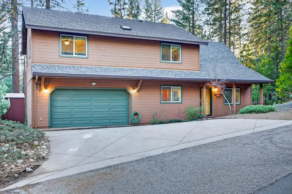 a front view of a house with garage