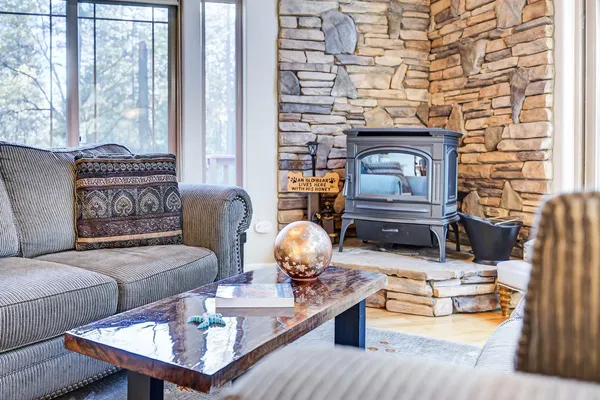 a kitchen with stainless steel appliances granite countertop a dining table chairs refrigerator and cabinets