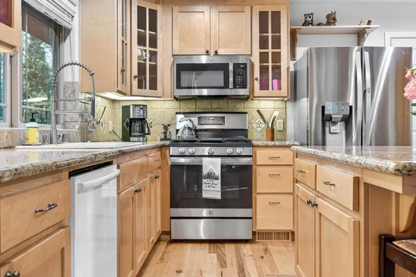 a vase of flowers sitting on a table in front of a window