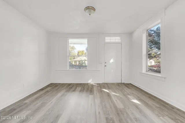 wooden floor in an empty room with a window