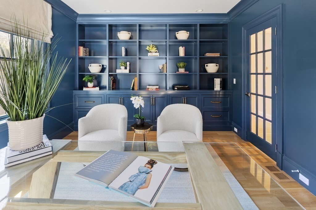 19 Longmeadow Road Wellesley, MA 02482 - Photo 14 of 34 a living room with furniture a bookshelf and a potted plant
