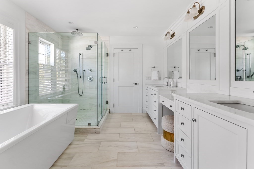 19 Longmeadow Road Wellesley, MA 02482 - Photo 18 of 34 a spacious bathroom with a granite countertop tub sink shower and mirror