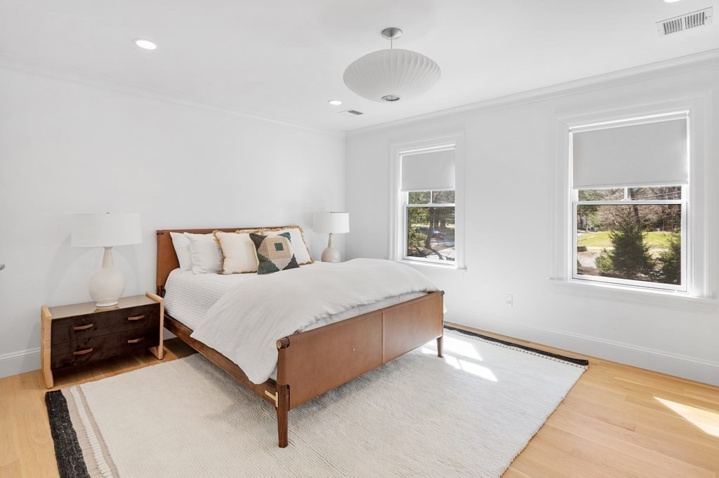 19 Longmeadow Road Wellesley, MA 02482 - Photo 21 of 34 a bedroom with a bed and wooden floor