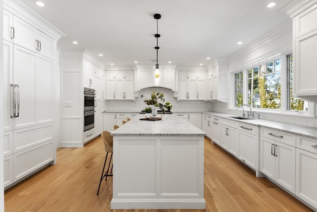 19 Longmeadow Road Wellesley, MA 02482 - Photo 3 of 34 a kitchen with kitchen island white cabinets and white appliances