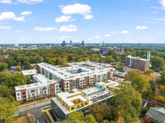 an aerial view of residential houses with city view