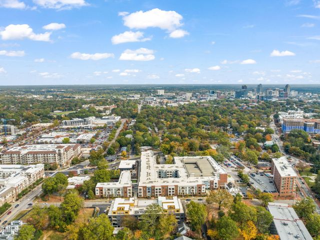 an aerial view of residential building with green space