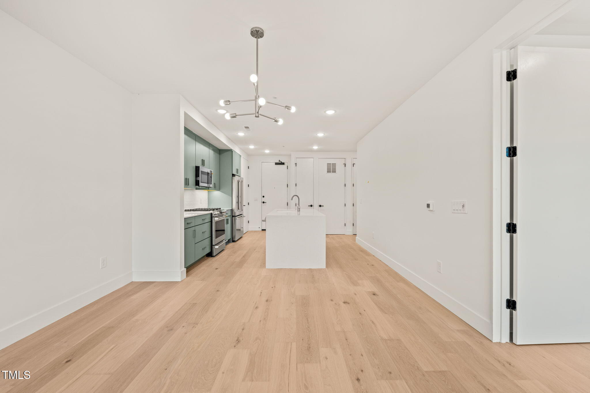 29 Enterprise Street, Unit 207 Raleigh, NC 27607 - Photo 4 of 36 a view of a kitchen with wooden floor